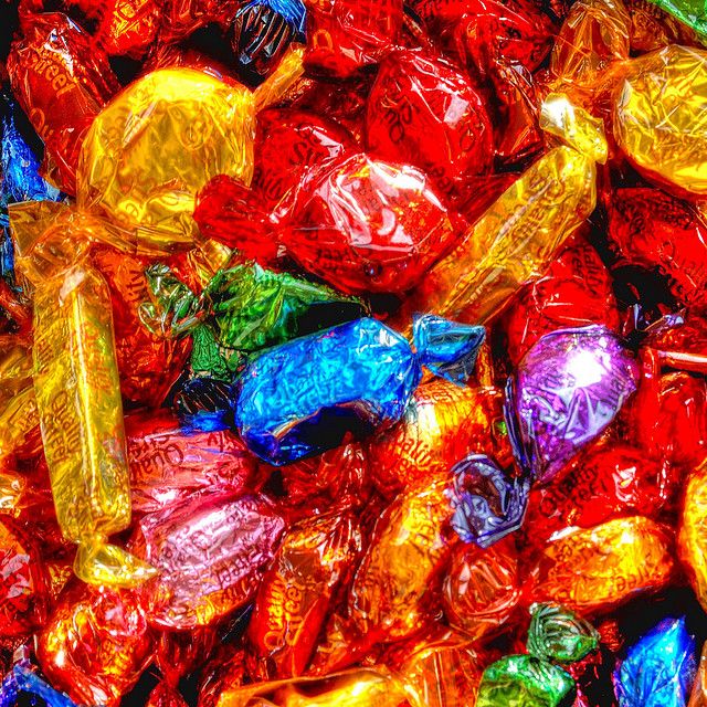 a pile of assorted candy wrapped in foil