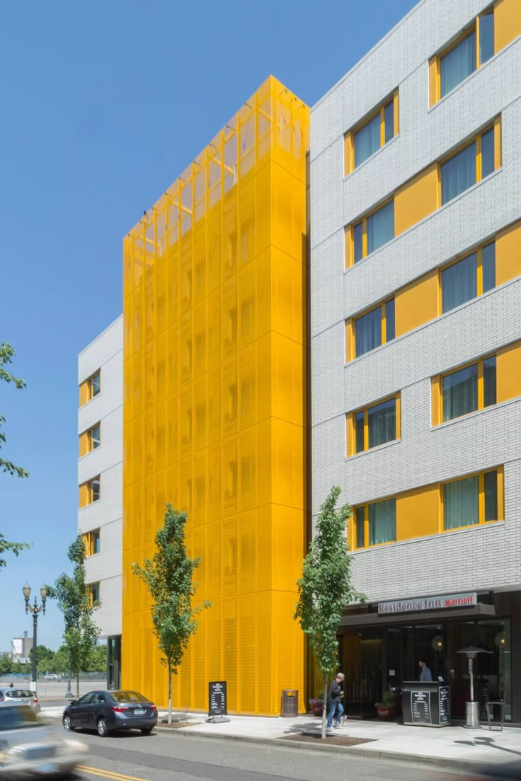 a large yellow building on the corner of a street