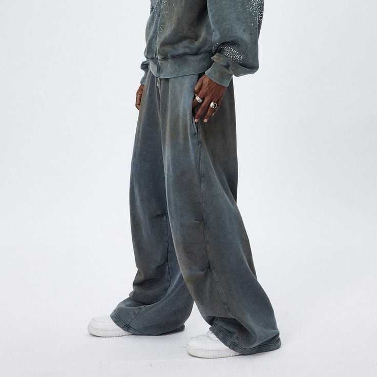 The Distressed Crinkled Baggy Sweatpants are a unique fusion of relaxed style and textured design. These sweatpants showcase a stonewashed, distressed look, creating a vintage and worn-in appeal that is both fashionable and comfortable. A distinctive feature of these pants is the double crinkled design strategically placed on both the inner and outer sides of the legs, adding an interesting visual and tactile element to the garment. The oversized silhouette of the pants offers a contemporary, re Sheff G, Streetwear Photoshoot, Baggy Sweatpants, Sweatpants Outfit, Mens Cardigan Sweater, Half Shirts, Varsity Jacket Men, Wide Leg Sweatpants, Jean Accessories