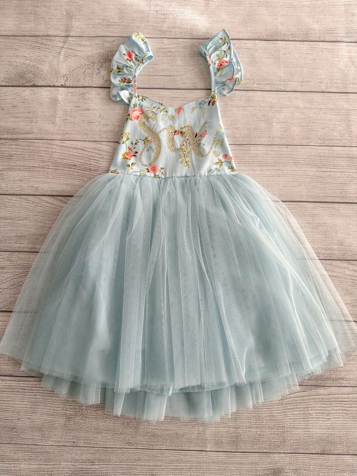 ♥ Product Information 100% Cotton in bodice and lining 100 % polyester tulle skirt Do not bleach This little girls party dress is perfect for any occasion, whether it would be for weddings flower girls dress, birthdays dress, Christmas gift, Easter dress, play wear and etc! Toddler tutu dress 's elastic back has a small loop to tie the strap crossover, adjust the length accordingly for a comfortable fit Beautiful baby dress has 4 layers exquisite fine tulle on the skirt with cotton lining to pro Spring Sleeveless Tulle Tutu Dress, Cute Spring Tulle Skirt Dress, Summer Princess Fairy Dress For Garden Party, Light Blue Princess Style Tutu Dress For Dress-up, Fitted Light Blue Princess Dress For Birthday, Spring Tutu Dress With Ruffles For Garden Party, Cute Spring Princess Dress For Party, Spring Garden Party Tutu Dress With Ruffles, Light Blue Tutu Dress For Summer Dress-up