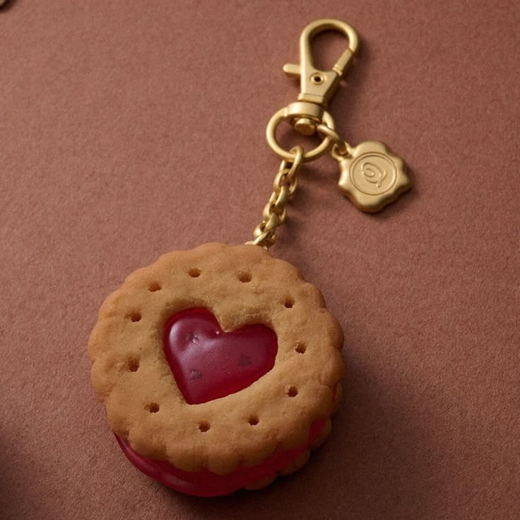 a cookie shaped keychain with a heart on it