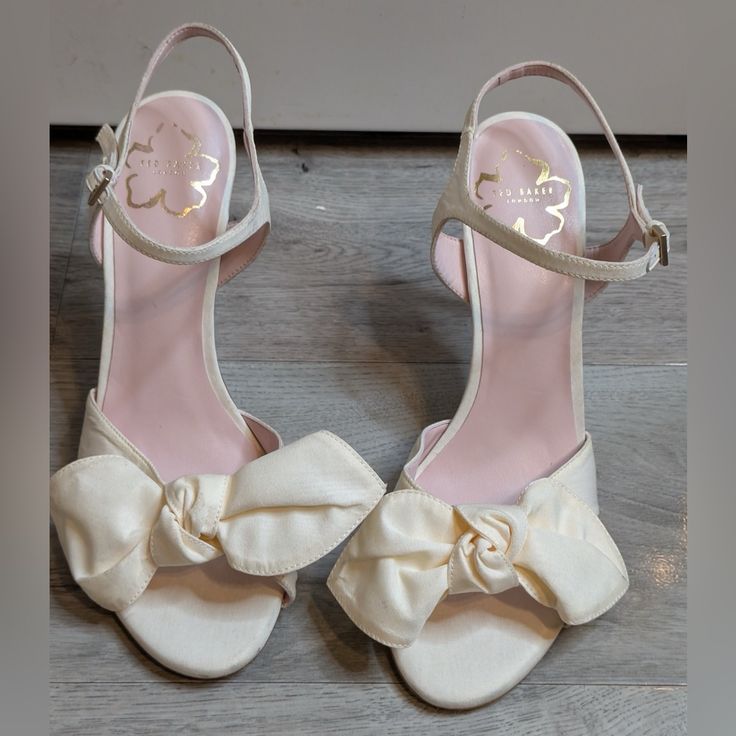 Ted Baker Heevia Moire Satin Bow Heeled Sandals Sz 39/Us9 New And Never Worn, But Was In A Bin With Other Dark Color Shoes. Has Some Small Marks Cream Open Toe Sandals With 4-inch Heel, Feminine Open Toe Wedding Shoes With 4-inch Heel, White Heels With Bow And Open Heel, White Open Heel Heels With Bow, Spring Wedding Shoes With 4-inch Heel Open Toe, Cream Round Toe Sandals For Evening, Cream Low Heel Sandals, Chic Wedding Shoes With Heel Strap And Open Heel, Cream Sandals With Padded Heel For Party