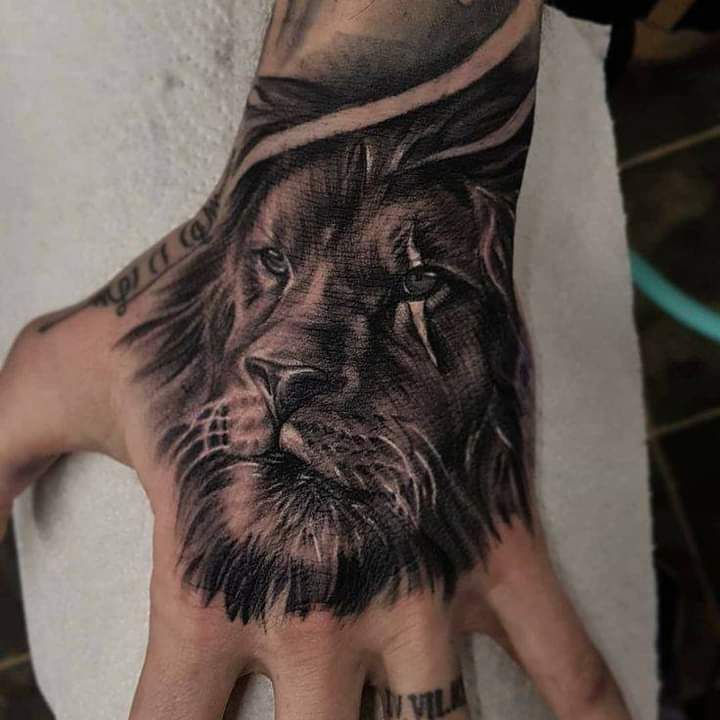 a man's hand with a lion tattoo on it, and the palm of his left hand