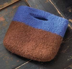 a blue and brown bag sitting on top of a wooden floor