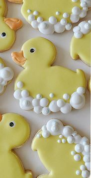 decorated cookies in the shape of rubber ducks