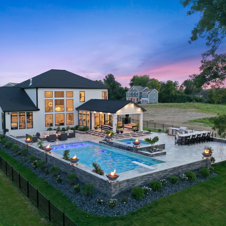 a large house with a swimming pool in the middle of it's lawn area