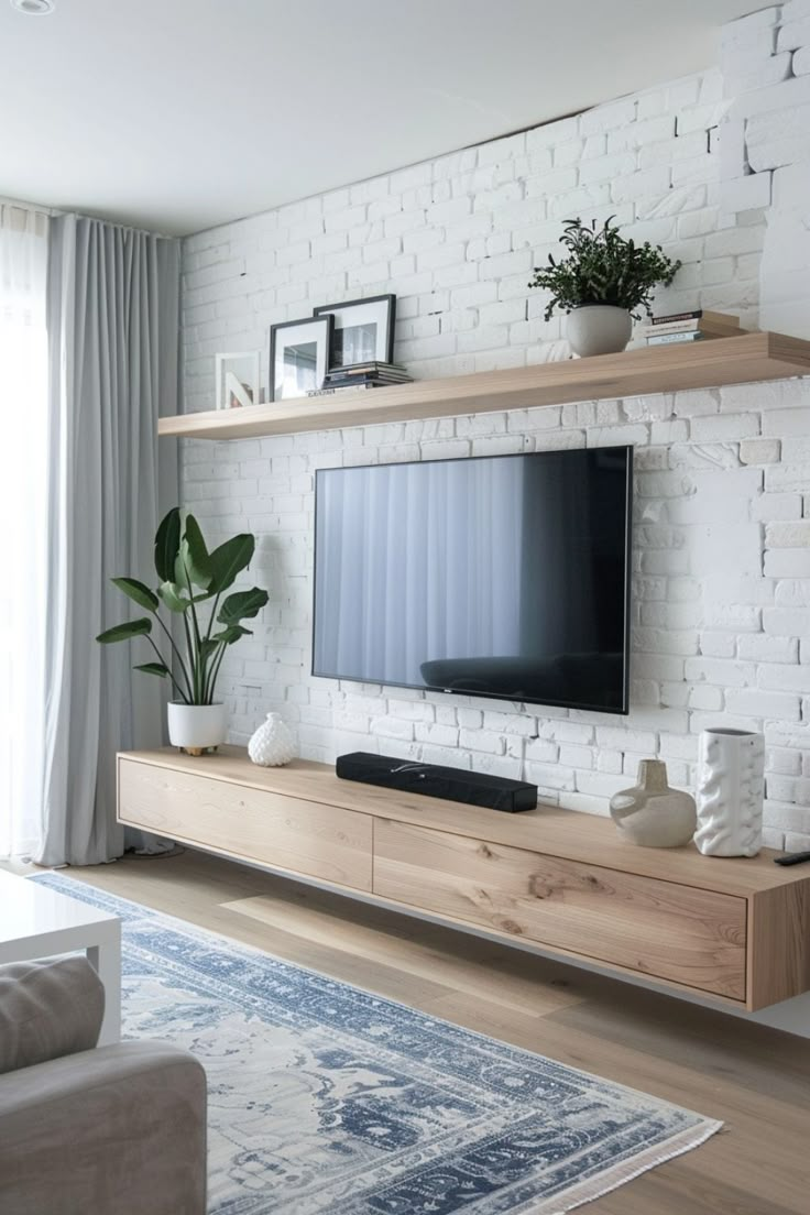 Upgrade your entertainment area with sleek, modern TV wall ideas. Click here to see more. Wallpaper Backgrounds Tv Wall, Tv On White Wall, Simple Tv Design, Tv With Floating Shelves Underneath, Floating Entertainment Center Decor, Wall Tv Stand Ideas Floating Shelves, Hanging Tv With Floating Shelves, Diy Tv Stand Built In, Decoration Around Tv Wall