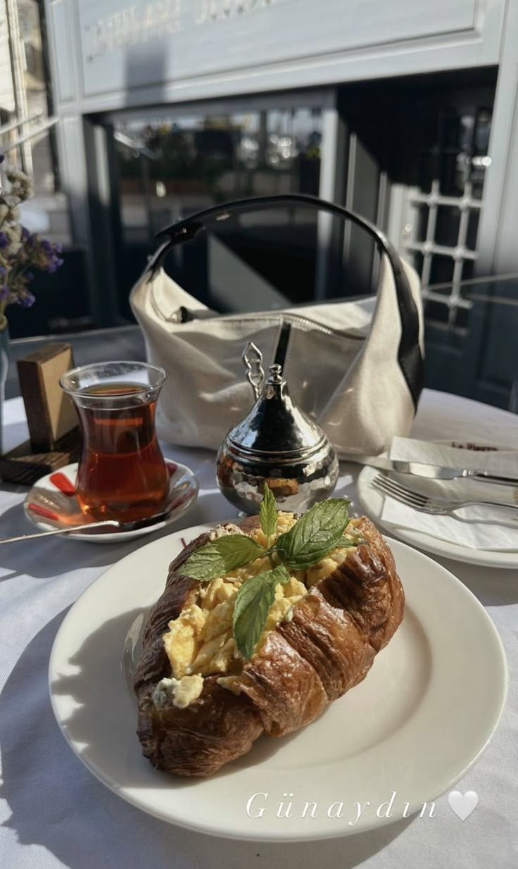 a white plate topped with food next to a tea pot