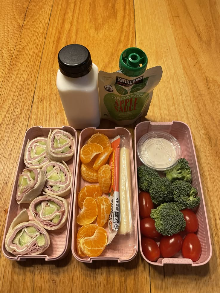 an assortment of fruits and vegetables in containers on a wooden table next to a bottle of milk