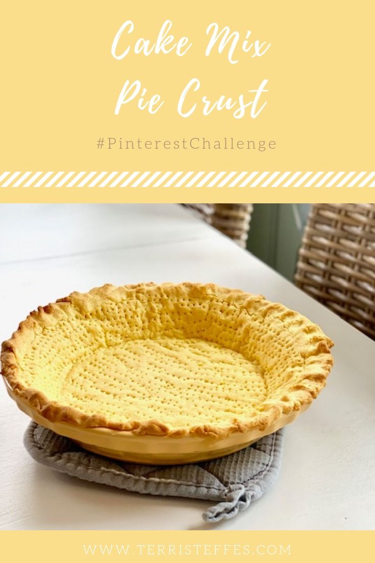 a pie crust sitting on top of a white table next to a wicker basket