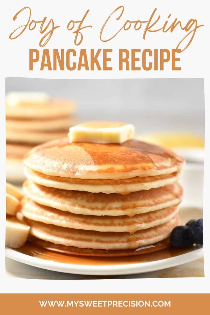 pancakes stacked on top of each other with butter and blueberries in the foreground