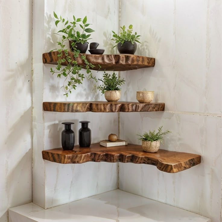 three wooden shelves with plants and vases on them in the corner of a room