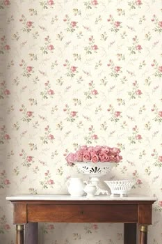 a table with vases and flowers on it in front of a wallpapered background