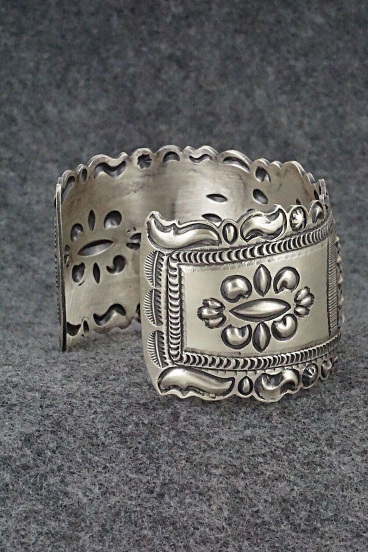 This stunning and intricate sterling silver bracelet was made by Navajo silversmith Eugene Charley. The inside is signed and stamped sterling.Size: 6" (will fit up to a 7 3/8" wrist)Gap: 1 3/8"Width: 1 1/2"Free shipping on all orders! We ship with USPS and always include tracking. All orders ship within a day of payment.Returns are accepted up to 30 days after you receive your order. Just send us a message. Our shop offers cash back or store credit. The item must be returned in new condition. Adjustable Ornate Sterling Silver Bangle, Bohemian Sterling Silver Bangle Stamped 925, Ornate Sterling Silver Bangle Jewelry, Ornate Antique Silver Sterling Bracelets, Bohemian Engraved Cuff Bracelet Collectible, Bohemian Engraved Jewelry For Collectors, Bohemian Engraved Jewelry Collectible, Collectible Intricate Design Jewelry Bracelet, Bohemian Engraved Collectible Jewelry