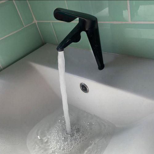 a faucet that is pouring water into a sink