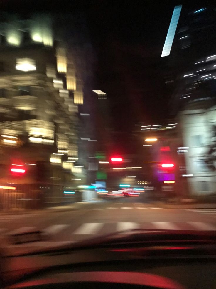 a car driving down a city street at night