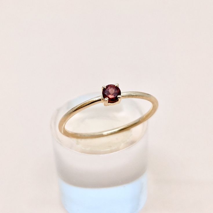 Natural Garnet Round Cut Gemstone Ring in 14k SOLID GOLD For Her from our Capsule Jewelry Collection.  Garnet Round Cut Stone is set in Prong Setting in our Factory. Gold Ring AAA+ Quality. Perfect Gift For Everyday or Gift for January Birthstone for Your Loved Ones. ►  DIMENSIONS : ◆ Gemstone : Garnet                       ◆ Stone size : 3*3 mm                           ◆ Gross Weight : 0.900 grams ◆ Shank Width : 1 mm        *  Material :  14k Yellow,White,Rose Gold      EACH Ring is Stamped W Classic Ruby Stackable Rings As A Gift, Classic Ruby Stackable Rings For Gift, 14k Gold Topaz Ring Gift, 14k Gold Round Diamond Ring With Birthstone, Fine Jewelry Yellow Gold Birthstone Ring, 14k Gold Topaz Birthstone Ring Gift, Fine Jewelry Yellow Gold Garnet Ring, Yellow Gold Crystal Ring With Round Band Gift, Yellow Gold Garnet Rings With Prong Setting