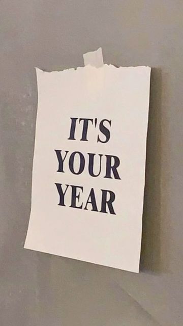 a piece of paper with the words it's your year on it hanging from a wall