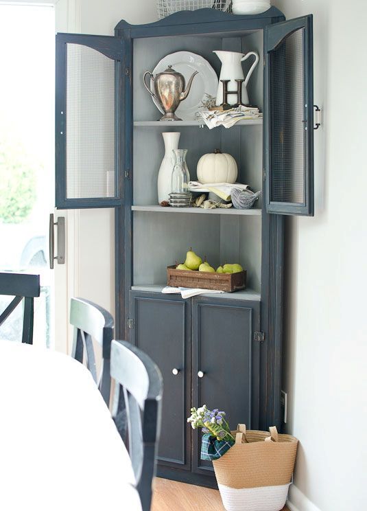 a china cabinet with plates and cups on it