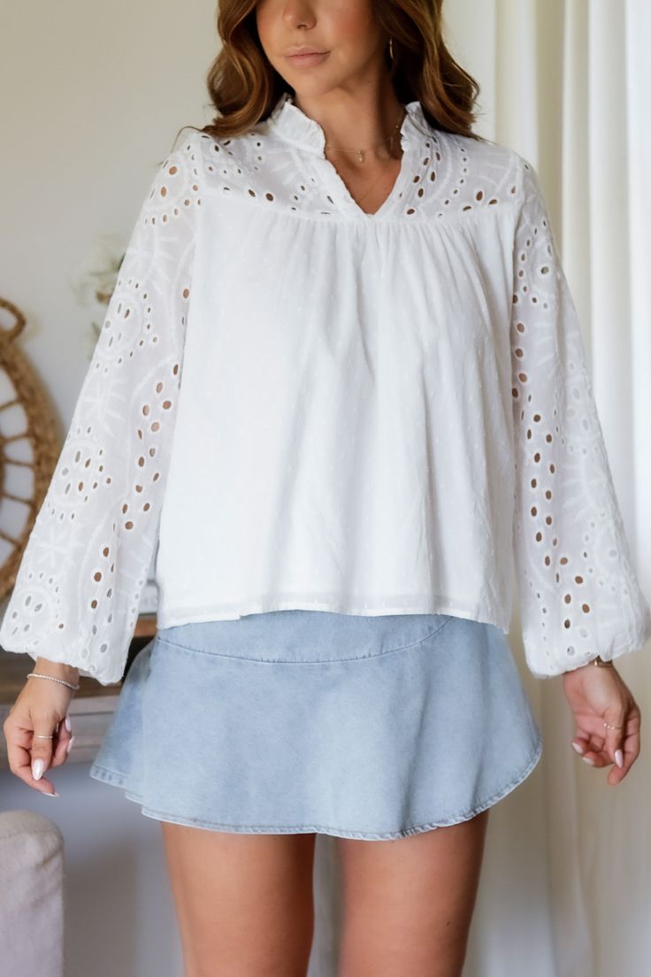 Add a touch of whimsy to your wardrobe with the Mandy Eyelet Blouse. Featuring delicate eyelet detailing, this blouse is sure to make you stand out. (Eyelet on point!) 65% Cotton 35% Polyester Color: White Long Sleeve Blouse All Over Eyelet Detail Light Weight Elastic Wrist Detail Double Lined in all the right placed Relaxed Flowy Style Ruffle Collar Detail Model is wearing a size Small. She is 5'6". 130lbs. Bust: 34" Waist 26" Hips 36" Chic Cotton Blouse With Cutwork Hem, Casual V-neck Eyelet Blouse, Elegant Eyelet Tops For Daywear, Cotton Blouse With Cutwork Hem For Daywear, Long Sleeve Blouse For Daywear With Cutwork Hem, Elegant Cotton Eyelet Tops, Chic Long Sleeve Tops With Cutwork Hem, Spring Daywear Blouse With Cutwork Hem, Long Sleeve Summer Tops With Cutwork Hem