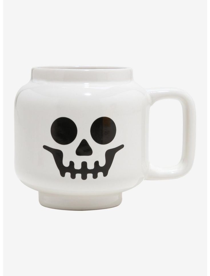 a white coffee mug with a skull face on it