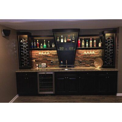 a home bar with wine bottles on the shelves