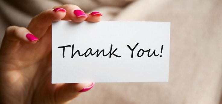 a woman holding up a card with the words thank you, allah written on it