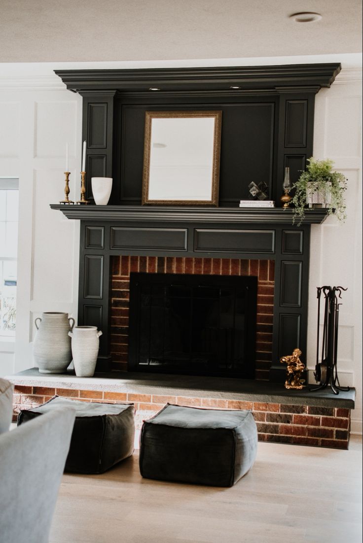 a living room filled with furniture and a fire place in front of a brick fireplace