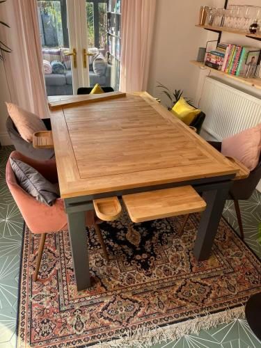 a wooden table sitting on top of a rug