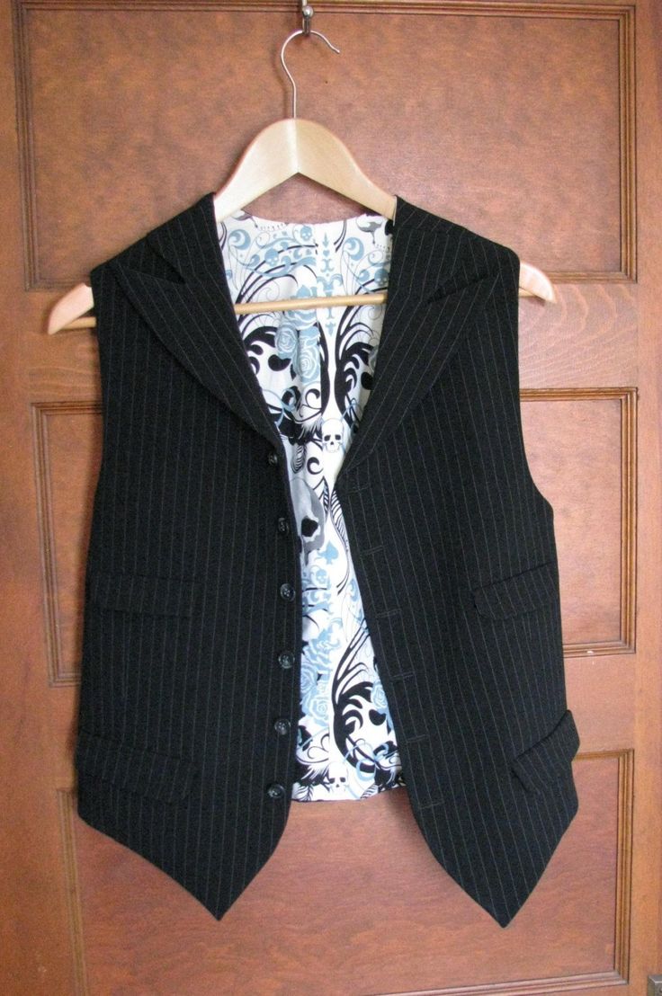 This is our latest vest style. Four pockets and wide peak lapels made for a unique look. This vest is vegan safe, cut from a stunning rayon/poly pinstripe fabric and lined in cotton with skull motifs. But you can choose from hundreds of fabrics including fine wools and silks. We can really make just about any type and style of vest that you can imagine. The matching tie and dress shirt shown in the pics are not included with this price, but we can make those also. Just contact us so we can get s Fitted Pinstripe Vest For Work, Tailored Pinstripe Sleeveless Vest, Pinstripe Tailored Sleeveless Vest, Tailored Sleeveless Pinstripe Vest, Classic Pinstripe Vest For Formal Occasions, Classic Pinstripe Formal Vest, Fitted Pinstripe Classic Vest, Classic Fitted Pinstripe Vest, Pinstripe Fabric