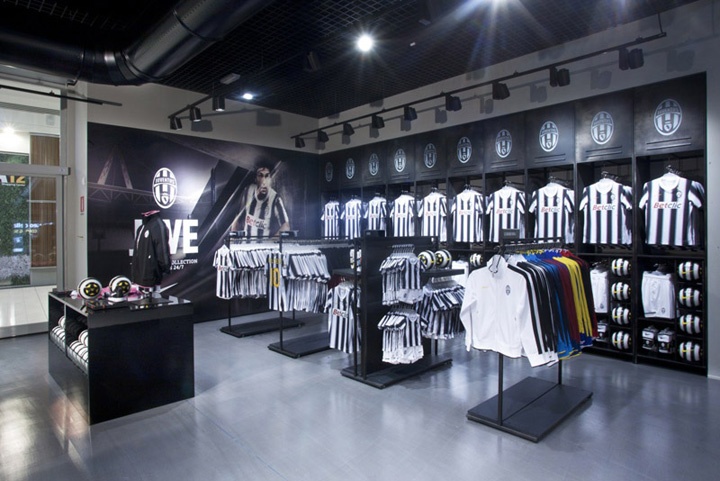 the inside of a soccer store with shirts on display