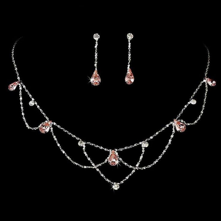 Pink Teardrop Crystal Wedding Jewelry Set Add vintage elegance to your wedding day or special occasion with this beautiful silver plated necklace and earring set. Clear round and pink crystal rhinestones glisten in a charming vintage inspired design. This jewelry set would be perfect for the bride or her bridesmaids as well as for prom. Size: The necklace is 15 1/2" long with a 3 1/2" extender. The pierced earrings are 1 1/4" long. Color: Silver/Pink. Style: ne8000p. Do you need several jewelry Woodland Fairy Wedding, Light Pink Jewelry, Prom Jewelry Sets, Bridgerton Wedding, Sapphire Jewelry Set, Pink Sapphire Jewelry, Pink Jewelry Set, Earring Bridal, Prom Necklaces