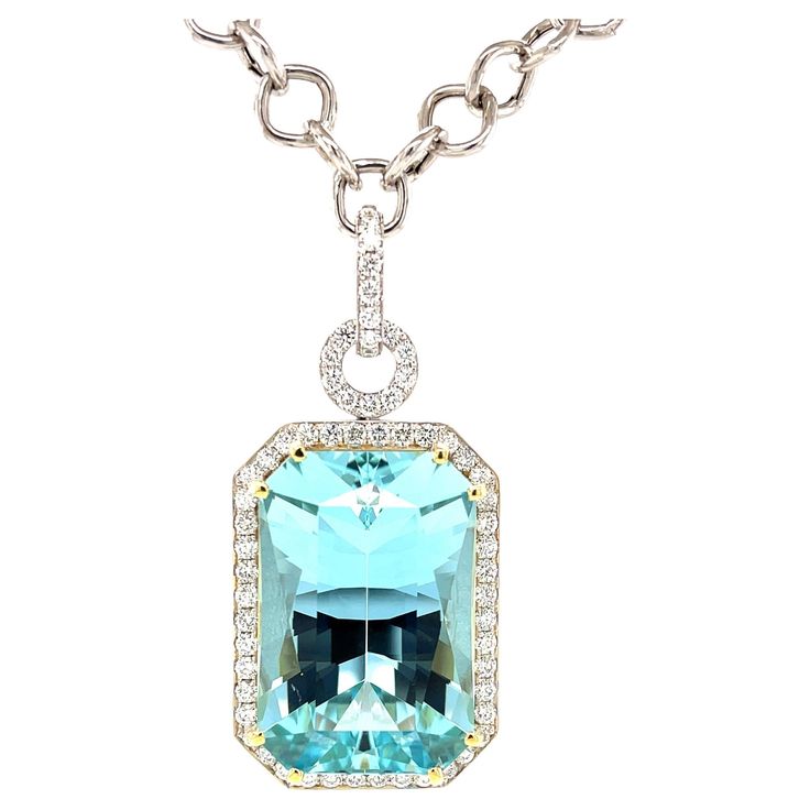 This stunning necklace features a magnificent 51.47 carat emerald-cut aquamarine with extraordinary blue color! The gem is surrounded by fine diamonds in an original pendant that is beautiful from every angle. The aquamarine is a perfectly proportioned "modified brilliant cut," with a rectangular outline and diamond-shaped facets that give this gemstone superior brilliance and life! We set this gorgeous blue gem in 18k yellow gold with double prongs and a custom designed 18k yellow gold basket. Luxury Aquamarine Solitaire Jewelry, Luxury Aquamarine Fine Jewelry Necklace, Aquamarine Emerald-cut Diamond Jewelry, Luxury Aquamarine Gemstone Necklace, Luxury Diamond-cut Blue Topaz Necklace, Diamond Enhancer, Gold Basket, Artisan Necklace, Gold Statement Necklace