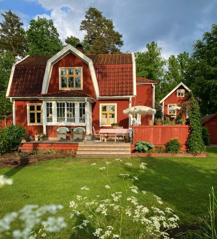 a red house with white trim and windows