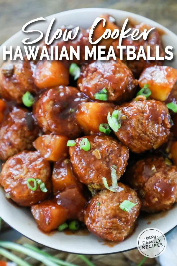 slow cooker hawaiian meatballs in a white bowl with green onions on the side