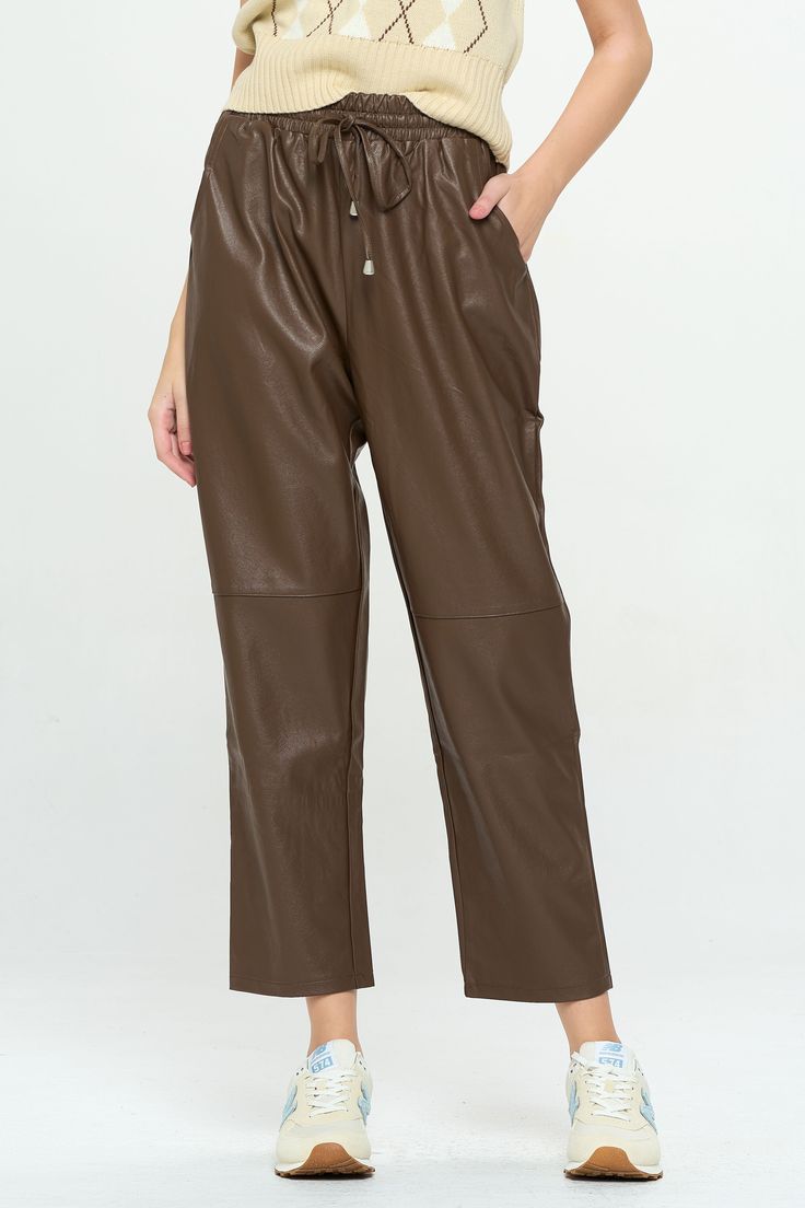 Edgy and comfortable, these faux leather pants feature a relaxed fit, wide, cropped legs, pockets and seams at the knees. An elastic waistband makes them perfect for on-the-go wear or dress them up with a strappy heel and bodysuit. Product Details Material: 50% Polyester, 50% PU; Lining: 100% Polyester. Fit: True to size. Relaxed fit.Length: 28" Inseam; 12" Rise (size Small). Fabric: Structured, woven fabric. Features: Drawstring elastic waistband, pockets, wide leg, soft faux suede interior lin Trendy Leather Bottoms For Spring, Spring Leather Pants With Pockets, Spring Straight Leg Solid Leather Pants, Spring Leather Straight Pants With Pockets, Fall Wide Leg Faux Leather Pants, Trendy Faux Leather Wide-leg Pants, Trendy Wide-leg Faux Leather Pants, Casual Leather Straight Pants, Trendy Wide-leg Leather Pants