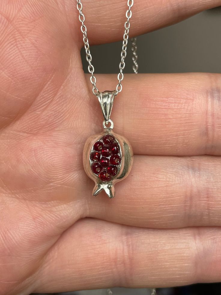 PENDENT Armenian necklace Pomegranate  100% Hand Made of 925 Sterling silver  FROM top quality Armenian MASTER Silver (not marked) + Material: silver + Stone: Zircon + chain: Silver size 42cm (16.5 inches)  Style 1 + Size [approximately]: 1.5cm (0.59 inches) + Weight [approximately]: 3.19 gr. Style 2 + Size [approximately]: 1.8cm (0.70 inches) + Weight [approximately]: 3.11gr. Style 3 + Size [approximately]: 1.5 cm(0.59- inches) + Weight [approximately]: 2.84 gr. For information (If you Want many we can do big discount, you must contact before) !!GOOD LUCK AND HAPPY BIDDING Feedback Positive Feedback is our life. If you have not received item in 30 days please contact us and we will try help. We need that all our buyers were happy. This is important. Shipping It takes approximately 15-25 d Silver Garnet Necklaces For Gifts, Pomegranate Necklace, Armenian Jewelry, Symbol Of Life, Handmade Chain, Dope Jewelry, Funky Jewelry, Hand Holding, Jewelry Lookbook