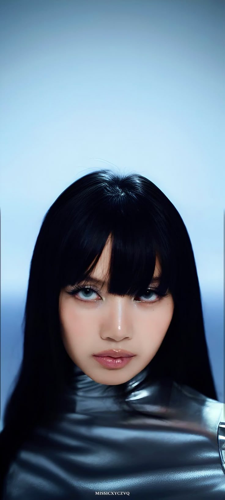 a woman with long black hair wearing a leather outfit and looking at the camera while standing in front of a blue background