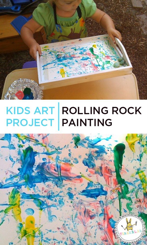 a child is painting with paint on the table and in front of it are pictures of children's hands