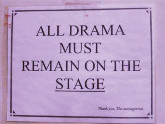 a sign on the side of a building that says, all drama must remain on the stage