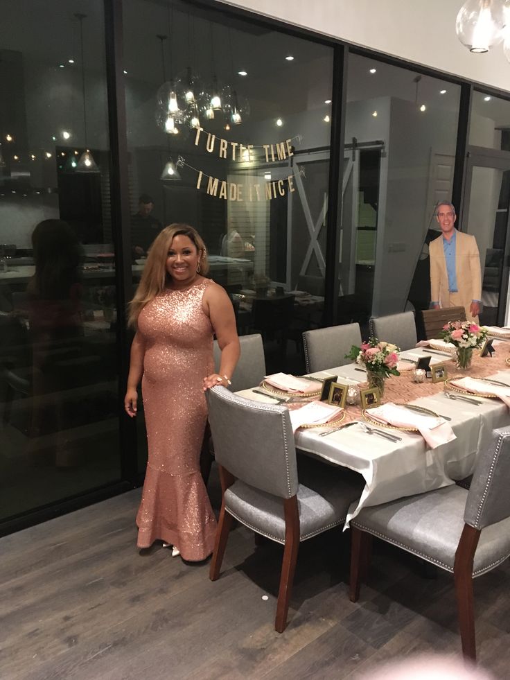 a woman standing in front of a long table