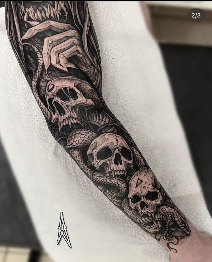 a man's arm with some skulls on it