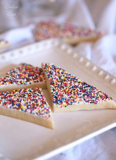 several pieces of cake with sprinkles on a plate