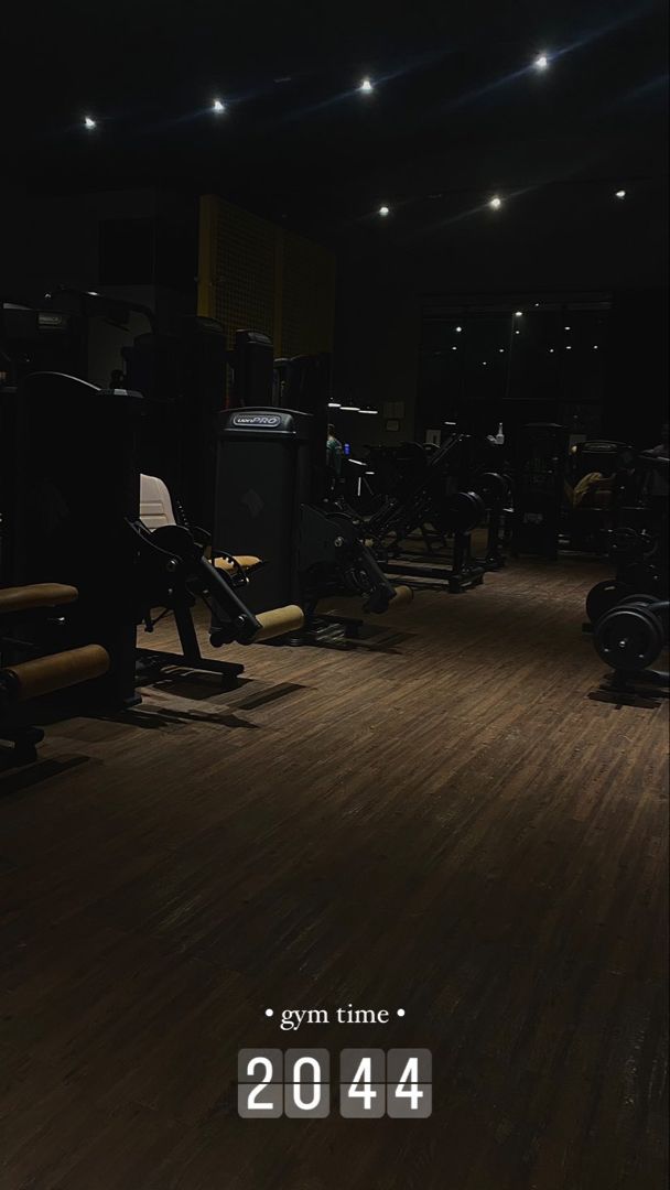 an image of a dark gym room with treadmills