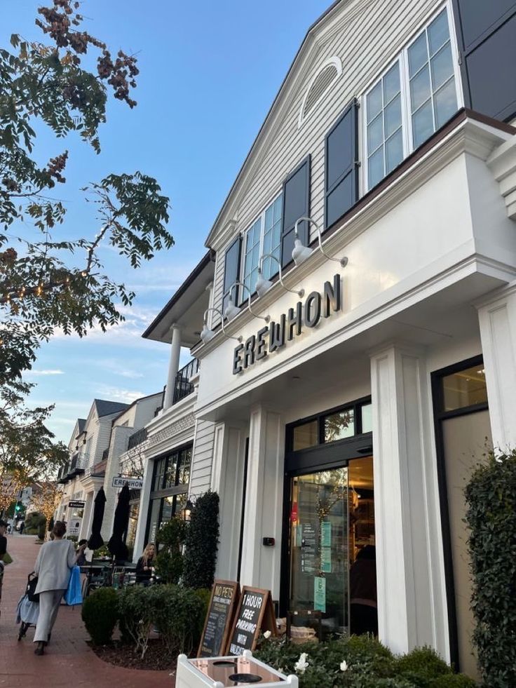 the exterior of a fashion store with people walking by