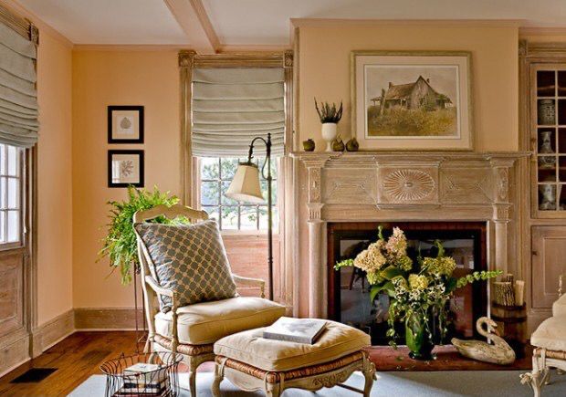 a living room filled with furniture and a fire place in front of a painting on the wall