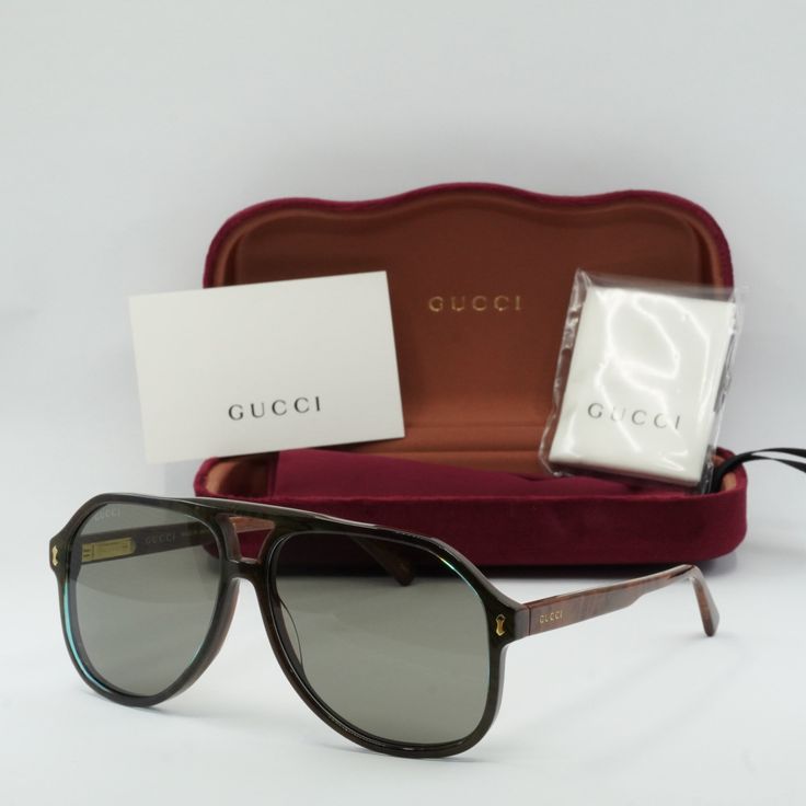 Welcome to OSSA FRAMES, your one-stop destination for luxury eyewear! Introducing the Gucci GG1042S 003 Blue/Brown/Grey aviator sunglasses, the epitome of style and sophistication for the modern man. Crafted by the renowned Italian fashion house Gucci, these sunglasses exude effortless elegance with their sleek design and high-quality materials. The frame color in an exquisite shade of blue perfectly complements the cool grey lenses, creating a striking contrast that is sure to turn heads wherever you go. The acetate frame material ensures durability and comfort, while the 60mm lens socket width provides ample coverage for optimal sun protection. With a temple length of 145mm and a bridge size of 13mm, these sunglasses are designed to fit comfortably on a variety of face shapes and sizes. Luxury Brown Shield Sunglasses With Gradient Lenses, Designer Brown Tinted Sunglasses, Gucci Casual Aviator Sunglasses With Uva Protection, Casual Gucci Aviator Sunglasses With Uva Protection, Designer Brown Shield Sunglasses With Gradient Lenses, Classic Gucci Aviator Sunglasses, Luxury Brown Shield Sunglasses With Polarized Lenses, Gucci Classic Aviator Sunglasses, Gucci Aviator Sunglasses With Tinted Lenses