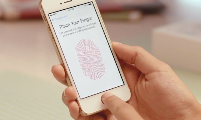 a person holding an iphone with a fingerprint on the screen