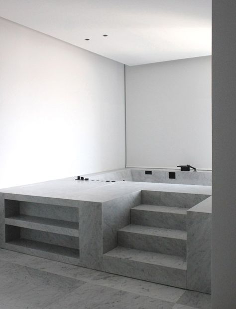 an empty room with concrete steps leading up to it