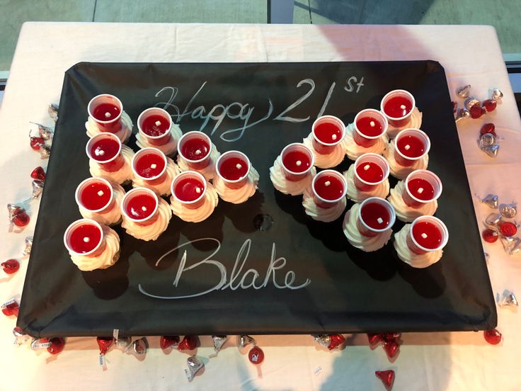 there are many cupcakes with candles in the shape of numbers on a black tray